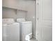 Laundry room with washer, dryer, and shelving at 21124 E 63Rd Dr, Aurora, CO 80019