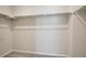 Large walk-in closet with double rods and neutral carpeting at 21124 E 63Rd Dr, Aurora, CO 80019