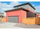 Two-story home with gray and coral exterior and wooden fence at 21124 E 63Rd Dr, Aurora, CO 80019