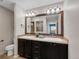 Double vanity bathroom with large mirror and tile backsplash at 4953 Cathay Ct, Denver, CO 80249