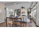 Bright dining area with wood floors and modern table, adjacent to a living room with fireplace at 4953 Cathay Ct, Denver, CO 80249