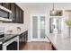 Modern kitchen with dark cabinetry, stainless steel appliances and an island with seating at 4953 Cathay Ct, Denver, CO 80249