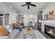 Open concept living room with a fireplace and views into the kitchen at 4953 Cathay Ct, Denver, CO 80249