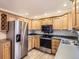 Bright kitchen, stainless steel appliances, wood cabinets, and granite countertops at 336 Aquarius Ct, Littleton, CO 80124