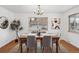 Spacious dining area with hardwood floors, farmhouse table, and chandelier at 4109 S Acoma St, Englewood, CO 80110