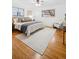 Main bedroom with hardwood floors, large windows, and ceiling fan at 4109 S Acoma St, Englewood, CO 80110