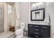 Modern bathroom with walk-in shower, toilet, and vanity with marble top at 11364 Birolli Pl, Littleton, CO 80125