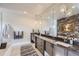 Spa-like bathroom with double vanity, large mirrors, and a soaking tub at 11364 Birolli Pl, Littleton, CO 80125