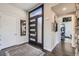 Bright and spacious entryway with modern dark wood front door at 11364 Birolli Pl, Littleton, CO 80125
