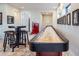 Basement game room with shuffleboard table and seating area at 11364 Birolli Pl, Littleton, CO 80125