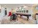 Basement game room with shuffleboard table, seating area and vintage Coca-Cola machine at 11364 Birolli Pl, Littleton, CO 80125