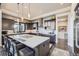 Modern kitchen with large island, dark cabinetry, and breakfast bar seating at 11364 Birolli Pl, Littleton, CO 80125