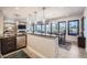 Open kitchen with breakfast bar and modern pendant lighting at 11364 Birolli Pl, Littleton, CO 80125