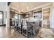 Modern kitchen with dark cabinetry and a large island at 11364 Birolli Pl, Littleton, CO 80125