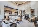 Spacious living room with stone fireplace and large windows at 11364 Birolli Pl, Littleton, CO 80125