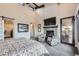 Main bedroom features a cozy fireplace and private access to outdoor space at 11364 Birolli Pl, Littleton, CO 80125