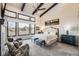 Luxurious main bedroom with high ceilings, fireplace, and access to private deck at 11364 Birolli Pl, Littleton, CO 80125