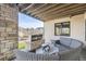 Covered patio with wicker furniture and an outdoor fireplace at 11364 Birolli Pl, Littleton, CO 80125