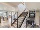 Basement stairs with modern metal railing and pin-ball machine at 11364 Birolli Pl, Littleton, CO 80125