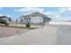 House exterior showcasing a gray house with stone accents and a driveway at 9935 E 163Rd Pl, Brighton, CO 80602