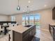 Open kitchen design with large island and view of backyard at 27431 E 10Th Dr, Aurora, CO 80018