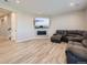 Spacious basement with fireplace and large sectional sofa at 27431 E 10Th Dr, Aurora, CO 80018
