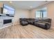 Finished basement with fireplace and large sectional sofa at 27431 E 10Th Dr, Aurora, CO 80018