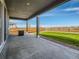 Covered patio with concrete flooring and grassy backyard at 27431 E 10Th Dr, Aurora, CO 80018