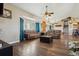 Open-concept living room with hardwood floors, fireplace and kitchen views at 54333 E County Road 26, Strasburg, CO 80136