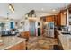 Kitchen features granite countertops, stainless steel appliances, and an island at 54333 E County Road 26, Strasburg, CO 80136