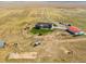 Aerial view of the property showing the house, outbuildings and surrounding land at 54333 E County Road 26, Strasburg, CO 80136