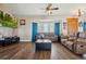 Living room with hardwood floors, comfy seating, and bay windows at 54333 E County Road 26, Strasburg, CO 80136