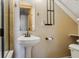 Small bathroom with pedestal sink, shower, and linen rack at 54333 E County Road 26, Strasburg, CO 80136