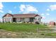 House exterior showcasing a spacious lawn and a country setting at 54333 E County Road 26, Strasburg, CO 80136