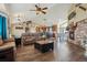 Open-concept living room with hardwood floors, fireplace and kitchen views at 54333 E County Road 26, Strasburg, CO 80136