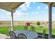 Relaxing patio with table and chairs, overlooking the backyard at 54333 E County Road 26, Strasburg, CO 80136