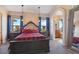 Main bedroom with ensuite bathroom and large windows at 54333 E County Road 26, Strasburg, CO 80136