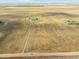 Wide aerial view of property with long driveway leading to the house at 54333 E County Road 26, Strasburg, CO 80136