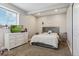 Cozy bedroom featuring a gray upholstered bed and white dresser at 54333 E County Road 26, Strasburg, CO 80136