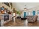 Spacious living room with a stone fireplace, hardwood floors, and ample natural light at 54333 E County Road 26, Strasburg, CO 80136