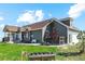 Green house exterior with a large yard, patio, and attached garage at 54333 E County Road 26, Strasburg, CO 80136