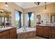 Bathroom features double vanity, soaking tub, and views at 54333 E County Road 26, Strasburg, CO 80136