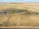 Wide aerial view of the property and surrounding farmlands at 54333 E County Road 26, Strasburg, CO 80136