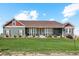 Ranch style home with green siding, red accents, and a large yard at 54333 E County Road 26, Strasburg, CO 80136