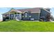 House exterior showcasing a large backyard, patio, and basketball hoop at 54333 E County Road 26, Strasburg, CO 80136