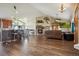 Open concept living room with hardwood floors, stone fireplace and kitchen at 54333 E County Road 26, Strasburg, CO 80136