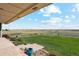 Scenic backyard view with expansive grasslands and a long driveway at 54333 E County Road 26, Strasburg, CO 80136