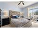 Main bedroom with king-size bed, balcony access, and built-in dresser at 5733 N Gibralter Way # 3-202, Aurora, CO 80019