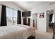 Spacious bedroom with a queen bed, dresser, and access to the bathroom at 5733 N Gibralter Way # 3-202, Aurora, CO 80019