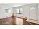 Living room featuring hardwood floors, large window, and a mirror at 10516 Humboldt St, Northglenn, CO 80233